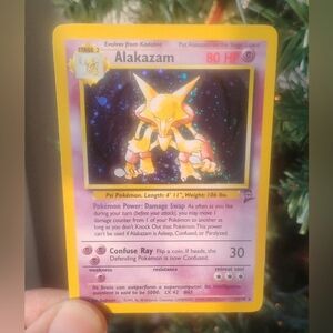 LP WOTC 2000 Holo Swirl Alakazam 1/130 Base Set 2 Pokemon Card